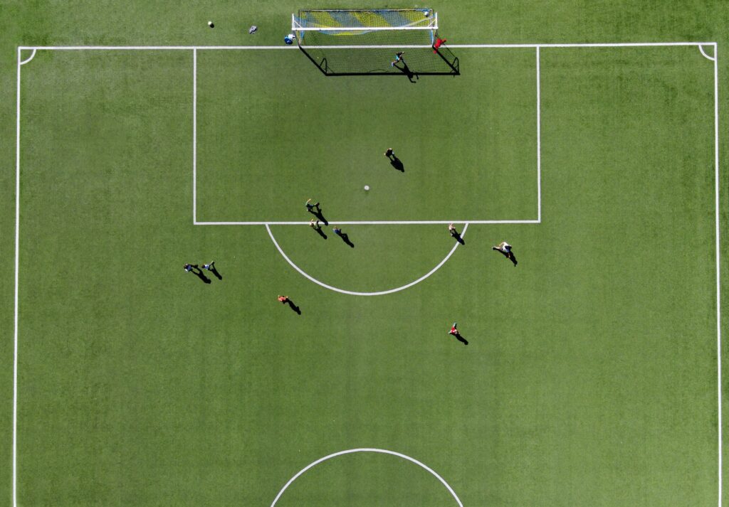 Soccer players on a green sports field